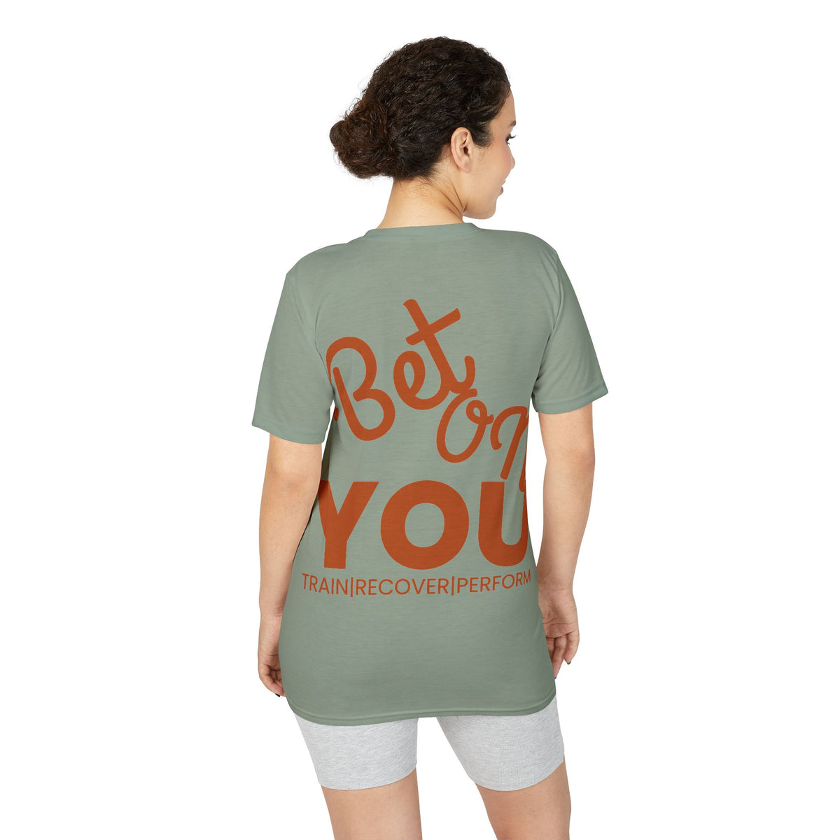 Model wearing sage green Bet On YOU performance T-shirt, back view with "Bet On YOU" print